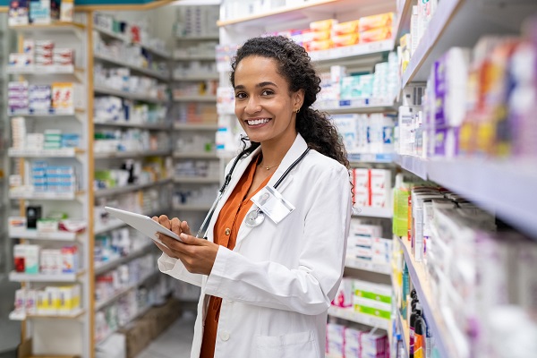Female pharmacist in front of rows of medication